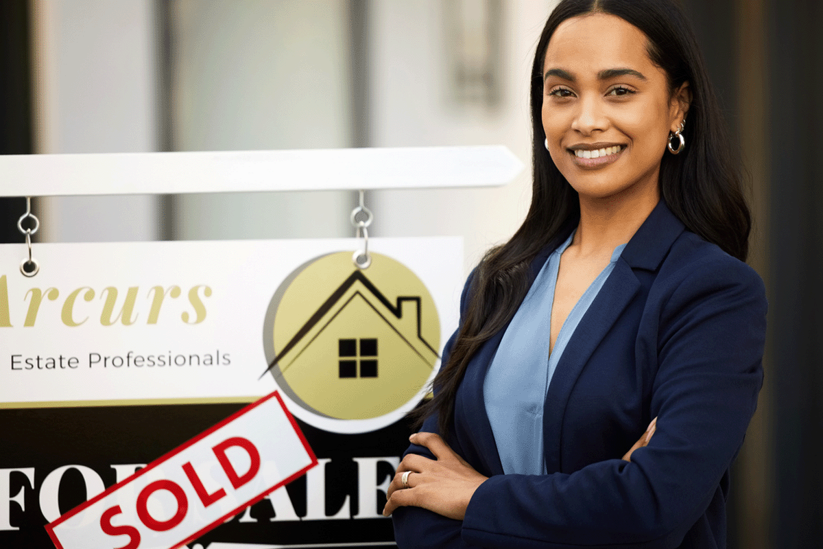 real estate agent standing in front of for sale sign with sold sticker