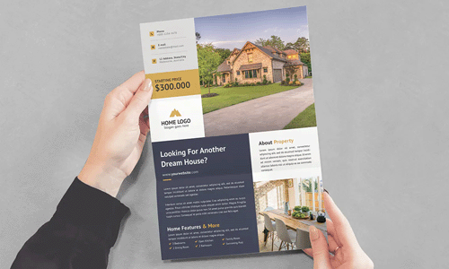 pair of hands holding a real estate brochure