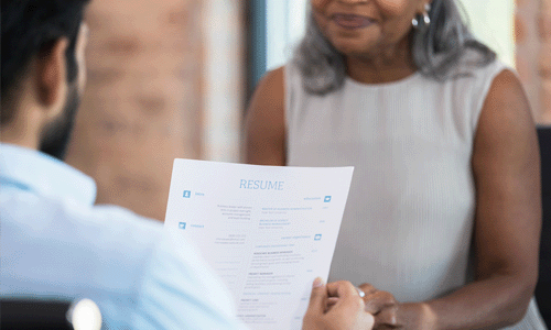 hiring manager reviewing resume in an interview with a candidate