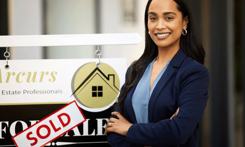 real estate agent standing in front of sold sign
